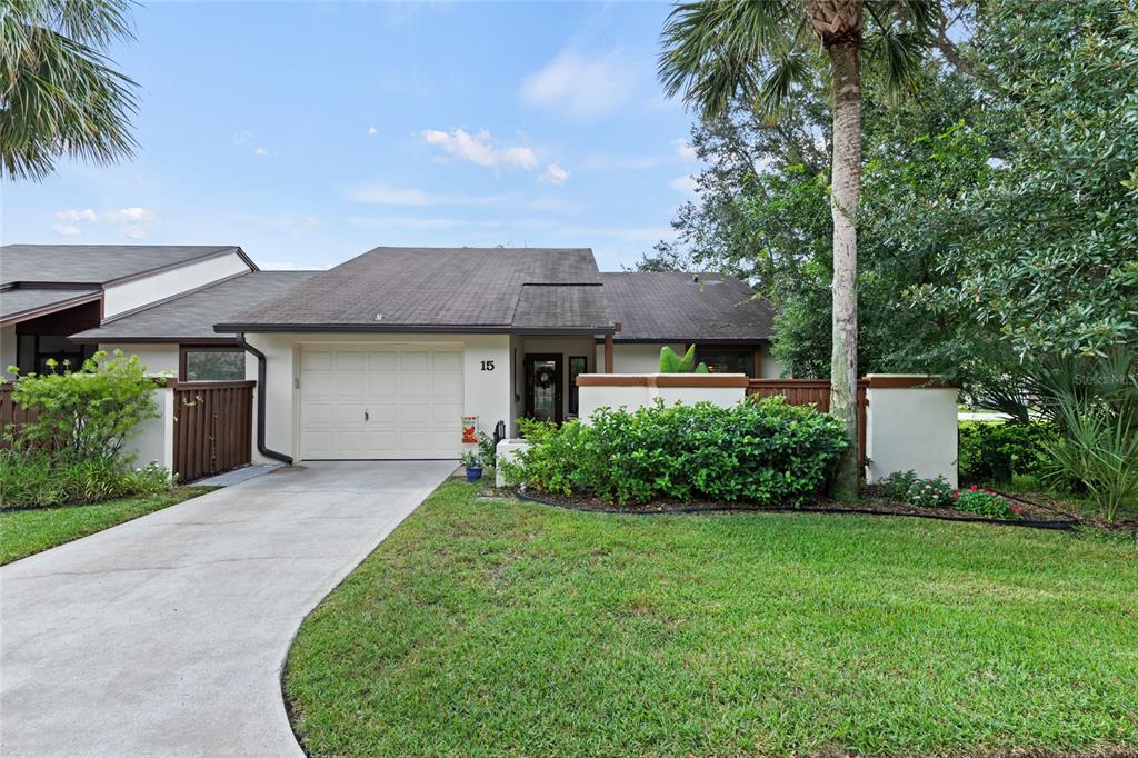 a view of a house with a yard and tree s