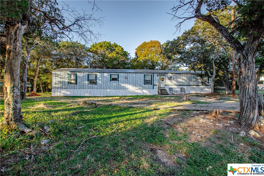 a view of house with outdoor space and swimming pool