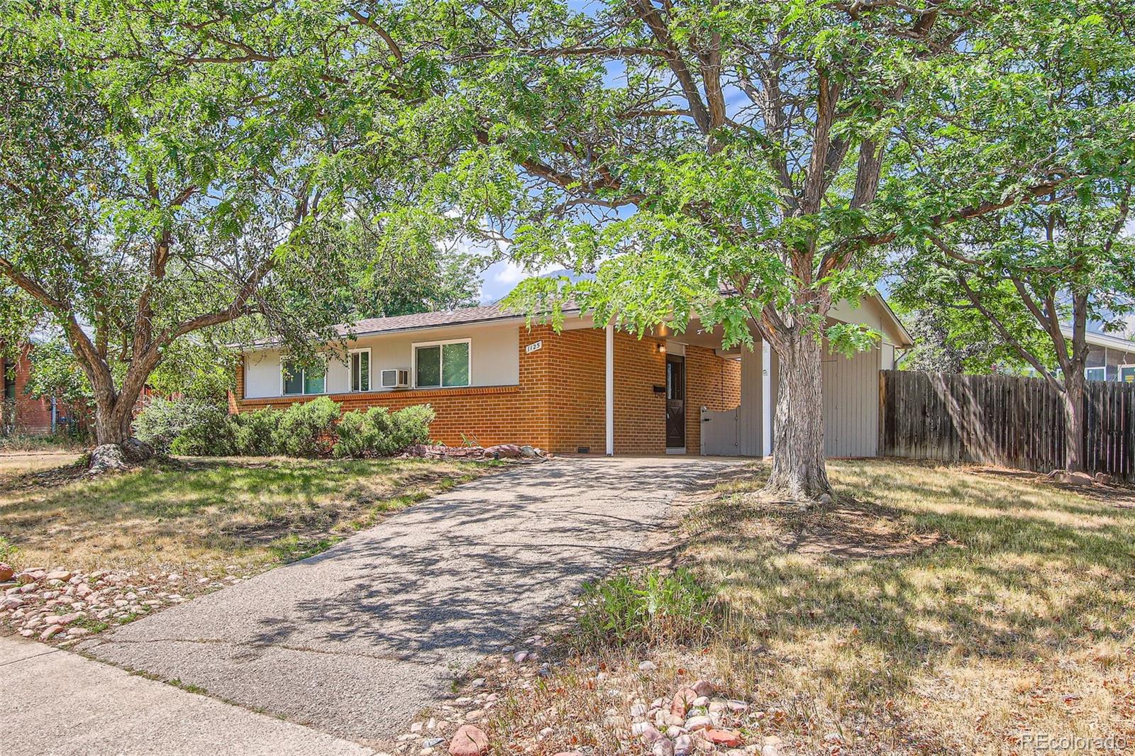 a house that has a tree in front of it