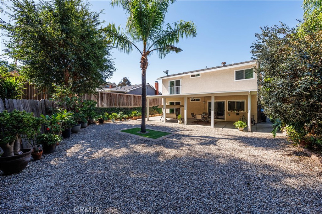 a view of a house with backyard and a garden