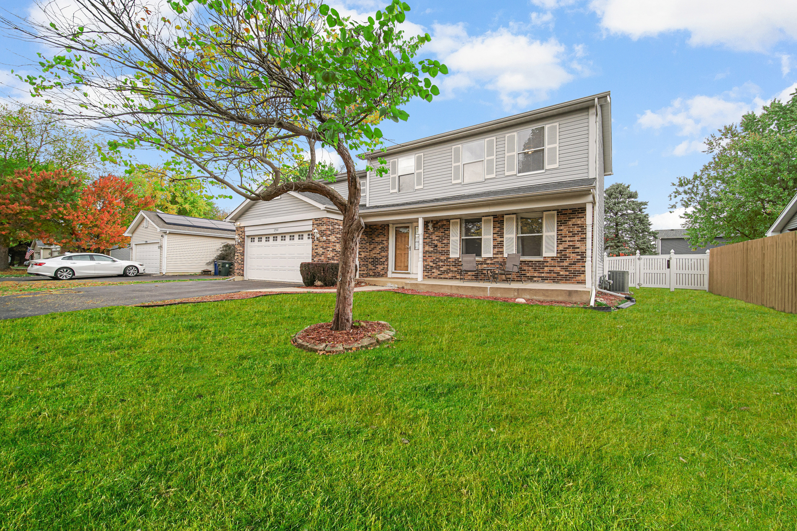 a front view of house with yard and green space