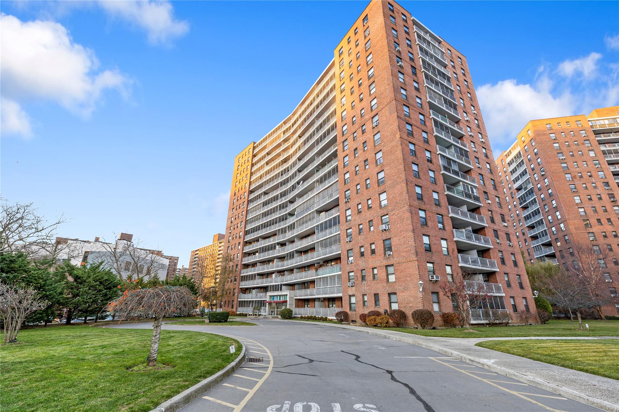 a view of a tall building next to a yard