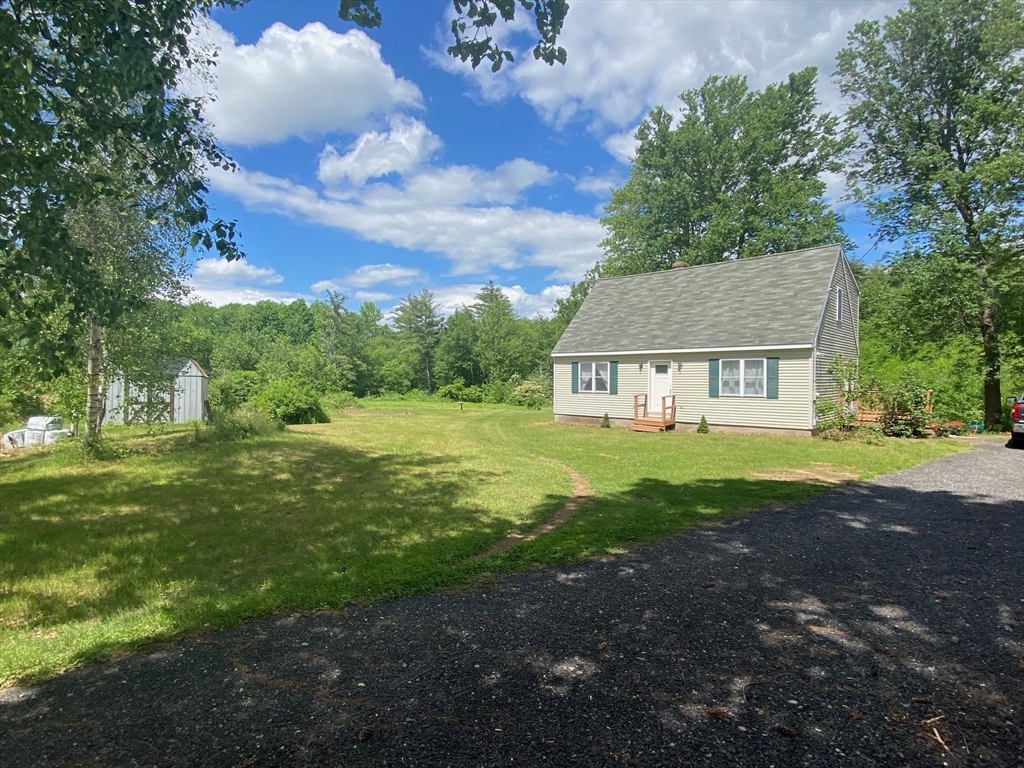 a view of house with backyard