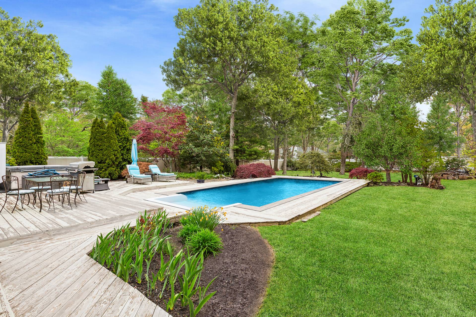 a view of a swimming pool with sitting area and garden