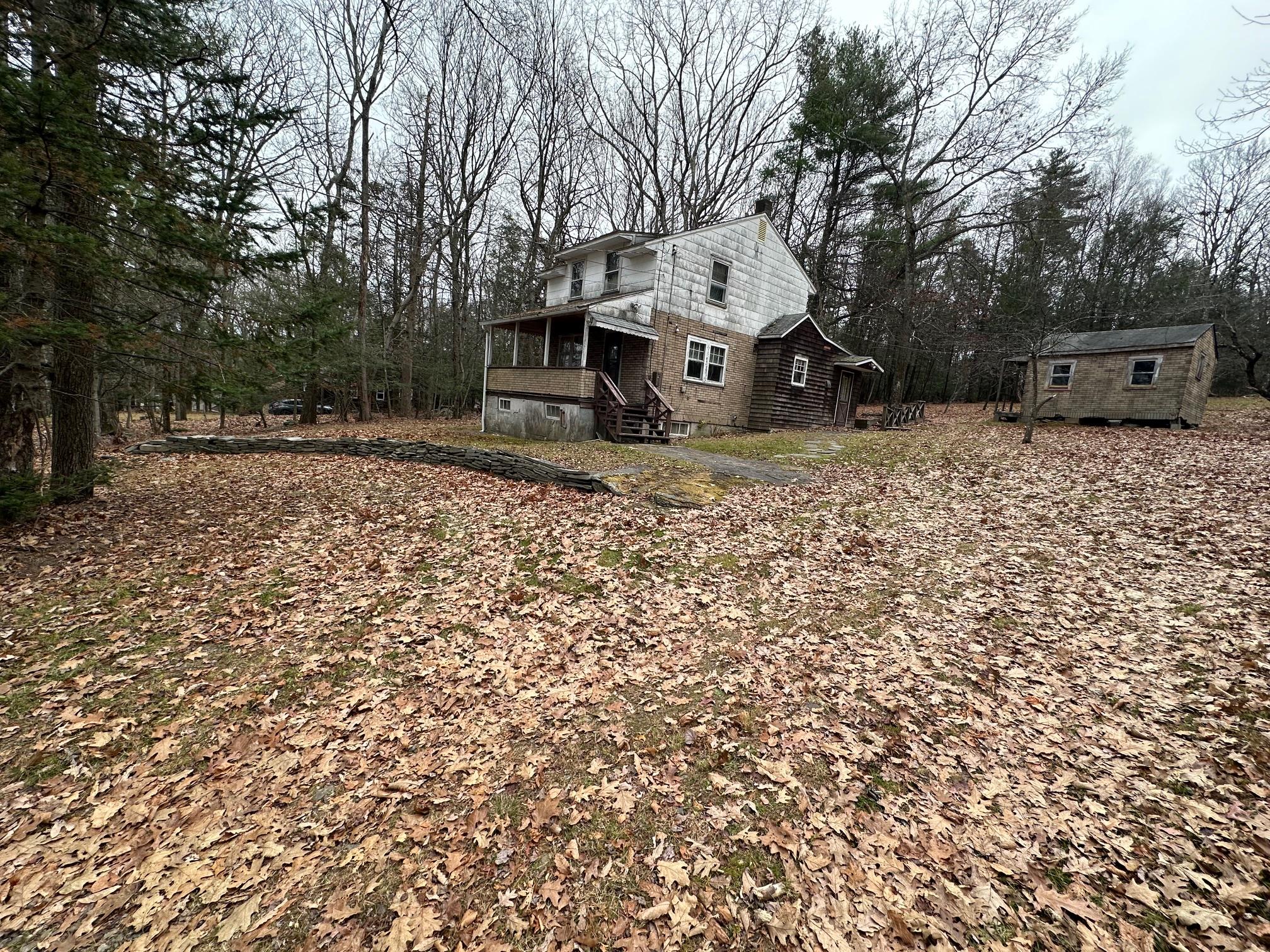 View of property exterior featuring a storage unit