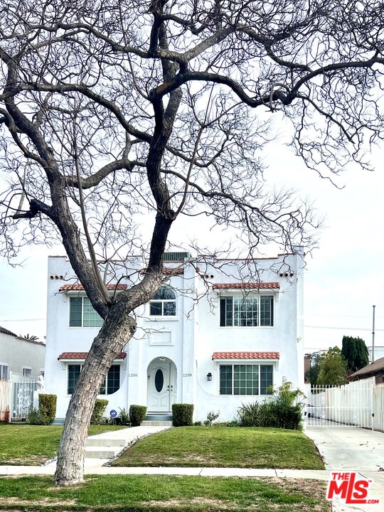 a view of white house with a yard