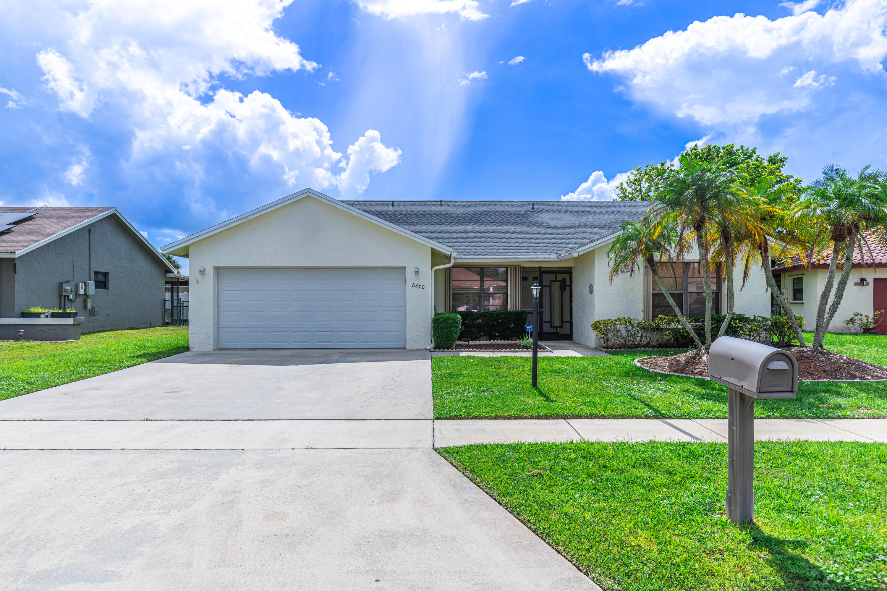 a front view of house with yard and green space