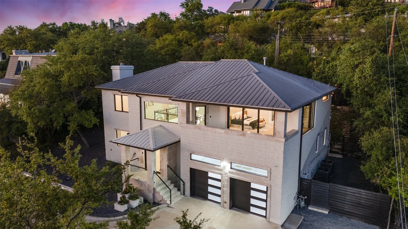 a aerial view of a house with balcony and trees