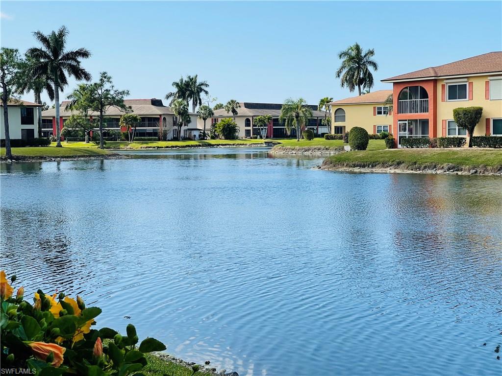 a view of swimming pool with outdoor seating and lake view