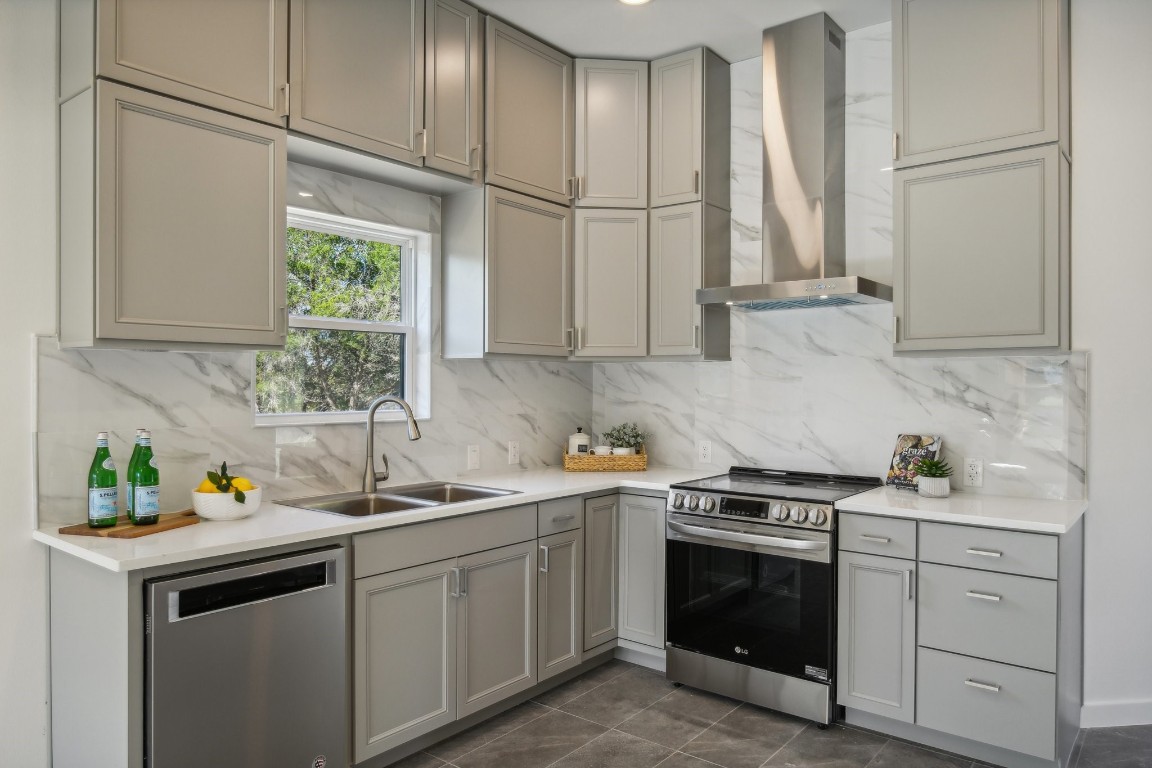 a kitchen with stainless steel appliances white cabinets and a sink