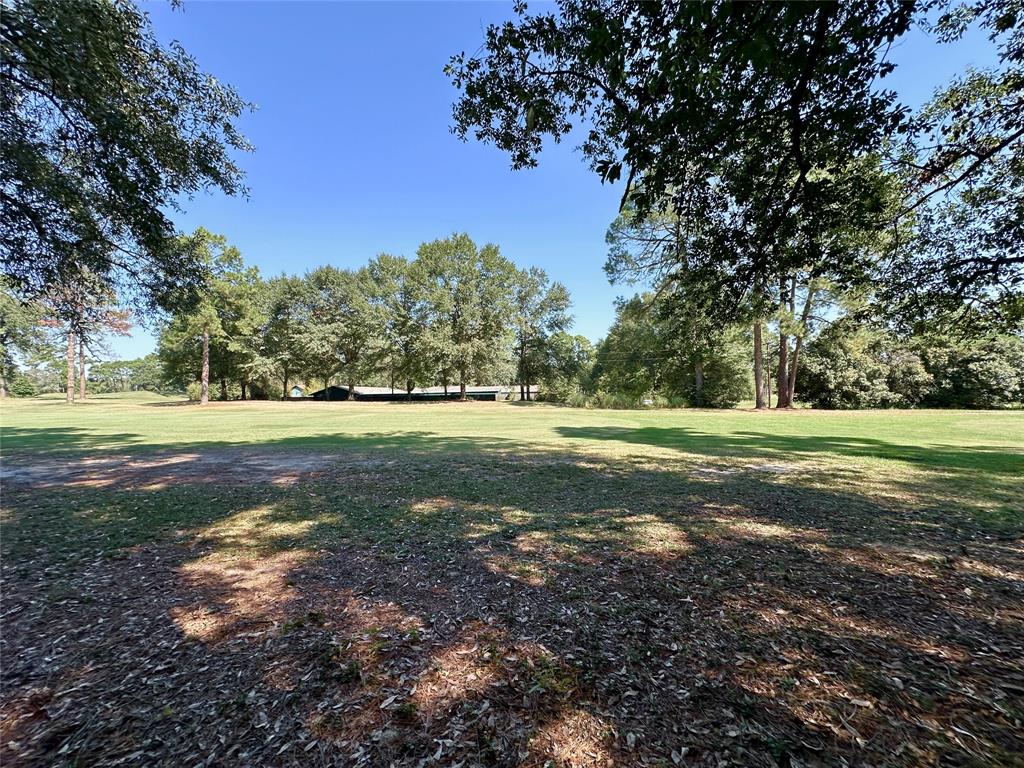 a view of a field with trees around