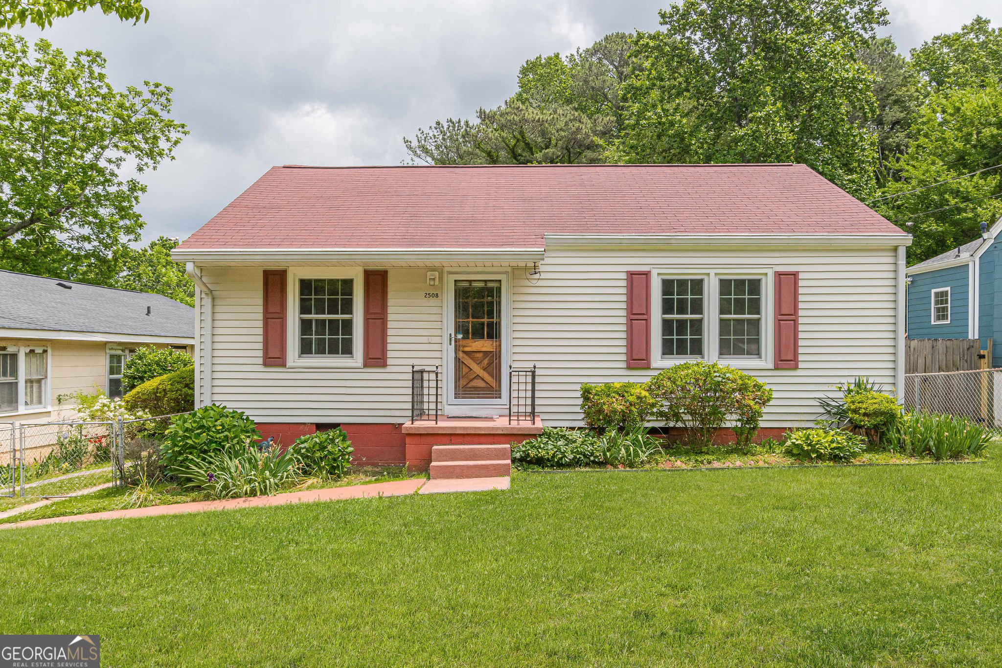 a front view of house with yard and green space