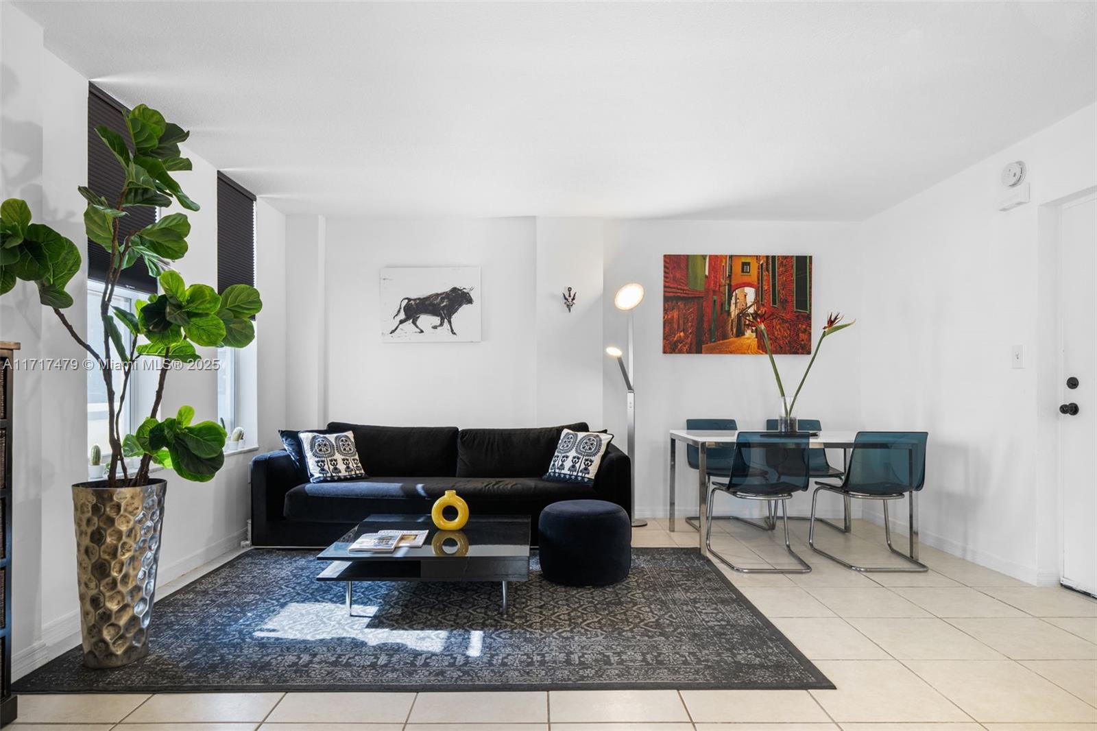 a living room with furniture and a potted plant