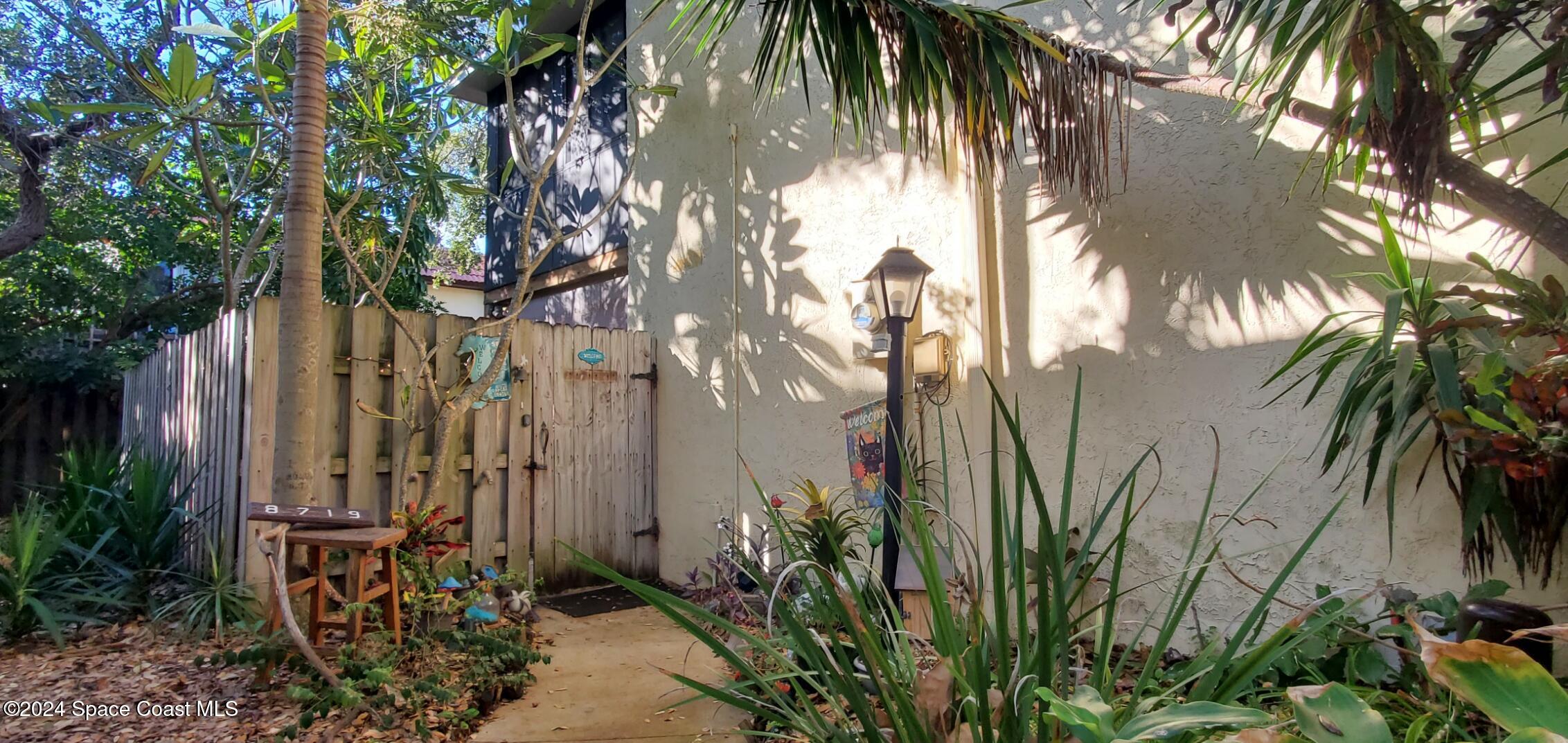 a couple of palm trees in front of a house