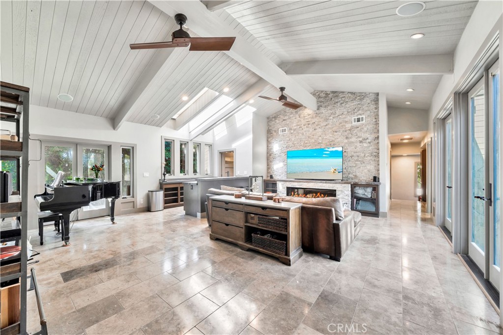 a view of a kitchen with stainless steel appliances kitchen island granite countertop a stove and a refrigerator