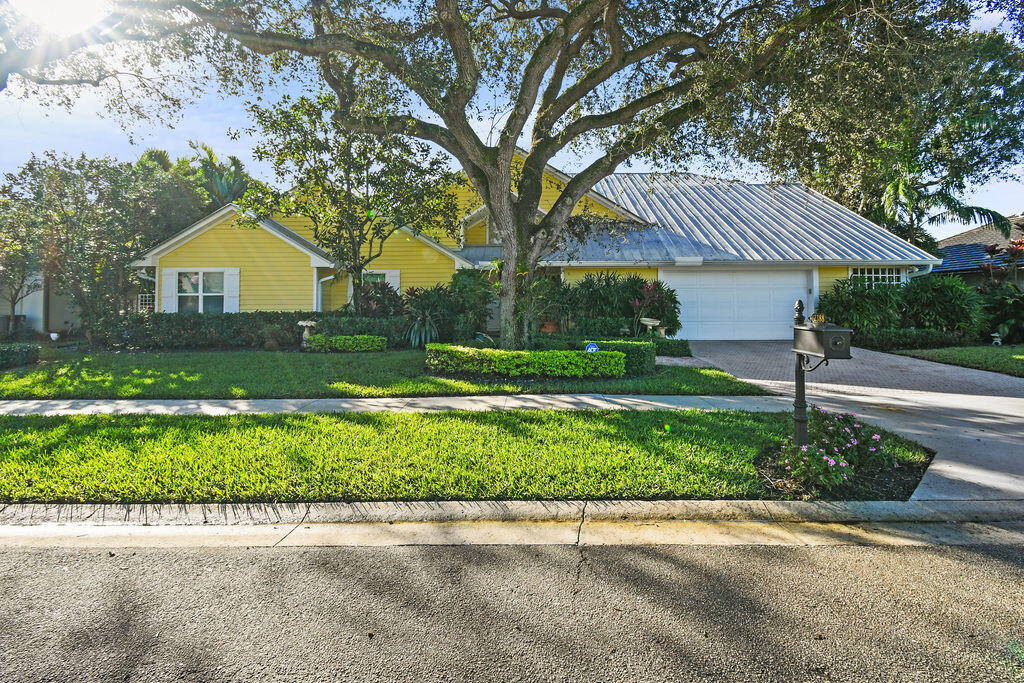 a front view of a house with a yard and a garage