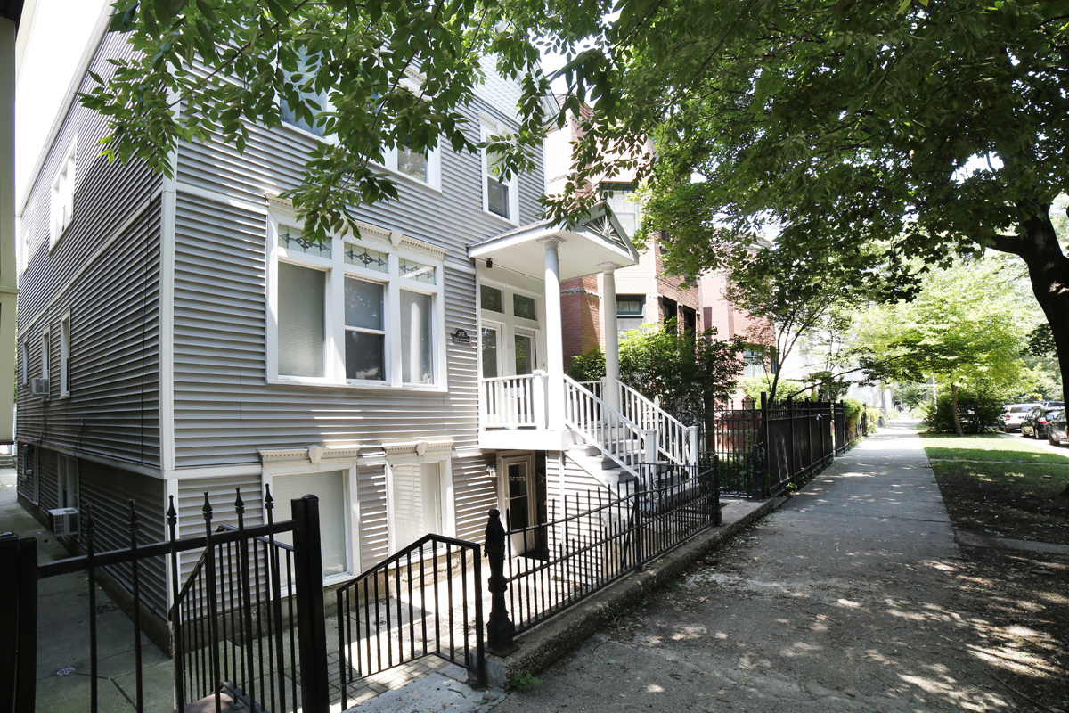 a front view of a house with iron fence