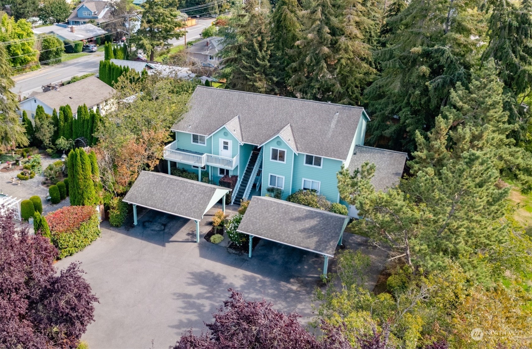 an aerial view of a house with garden space and street view