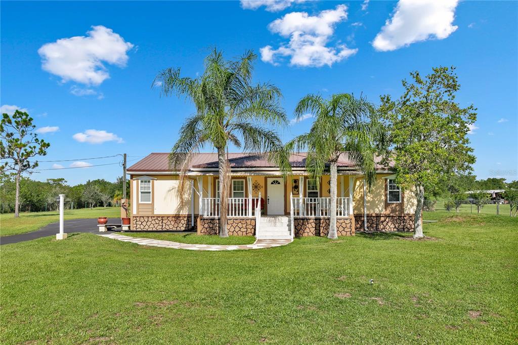 a view of a house with a backyard porch and sitting area