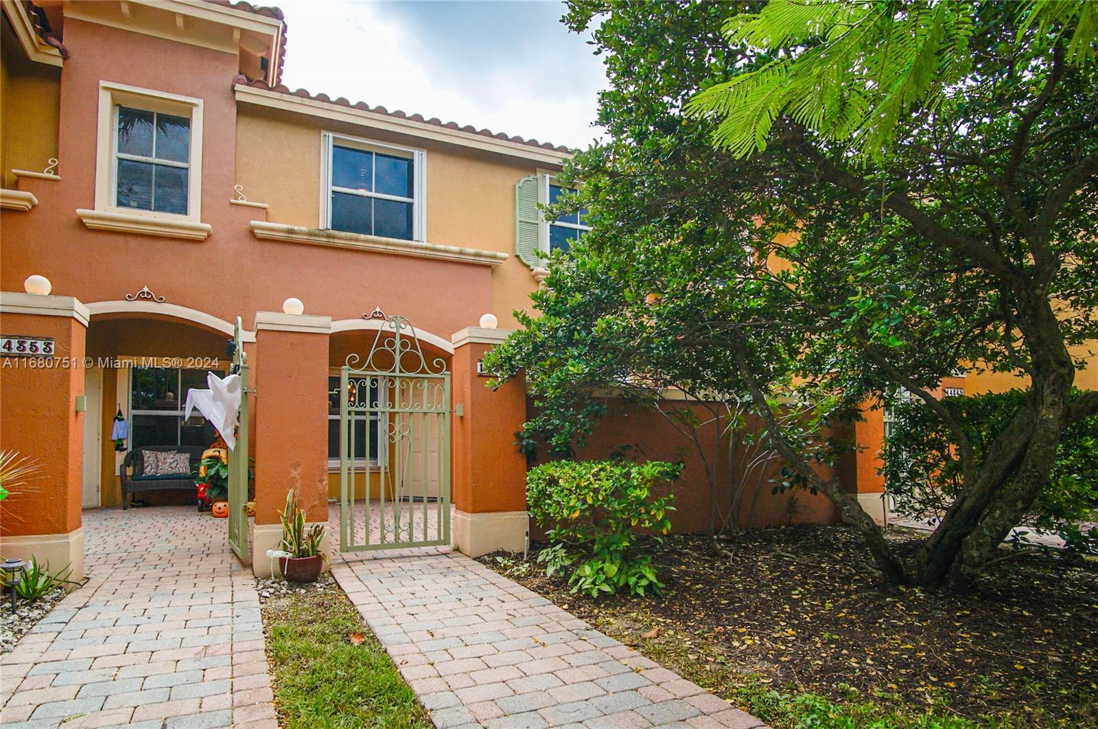 a front view of a house with garden