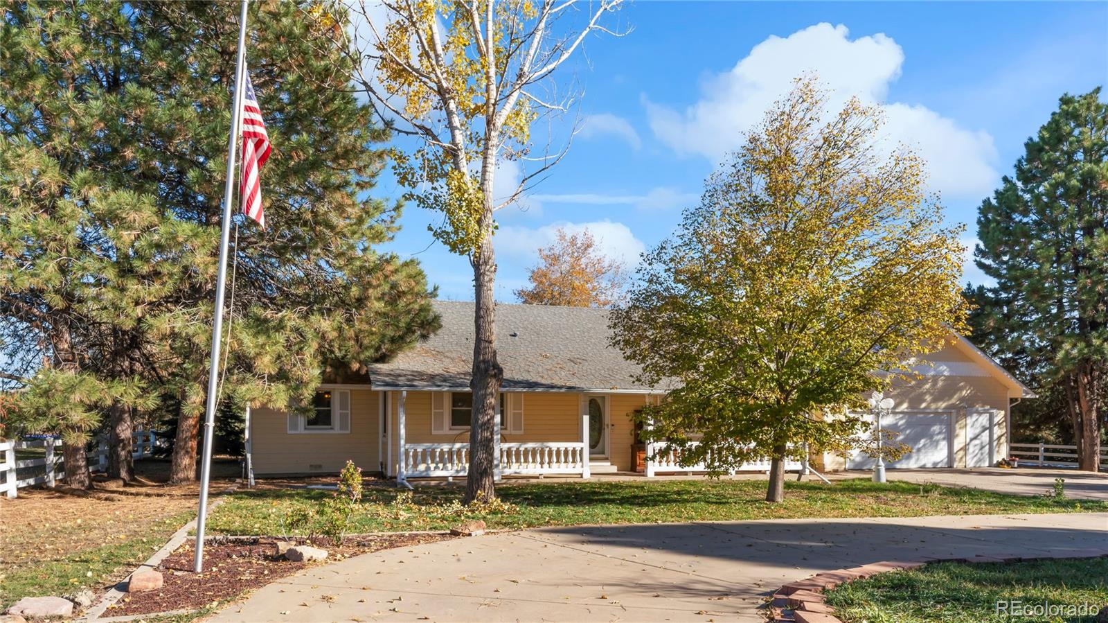 a front view of a house with a yard and trees