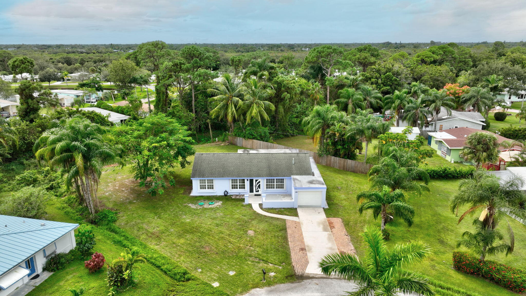 an aerial view of a house with yard