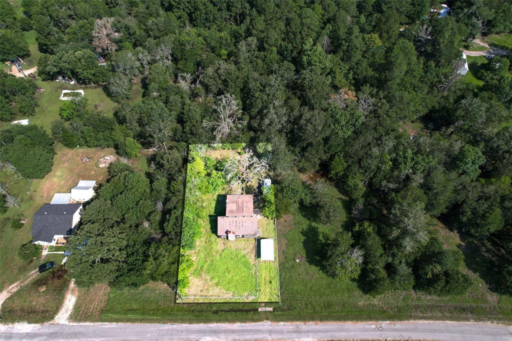 an aerial view of a house with a yard basket ball court and outdoor seating