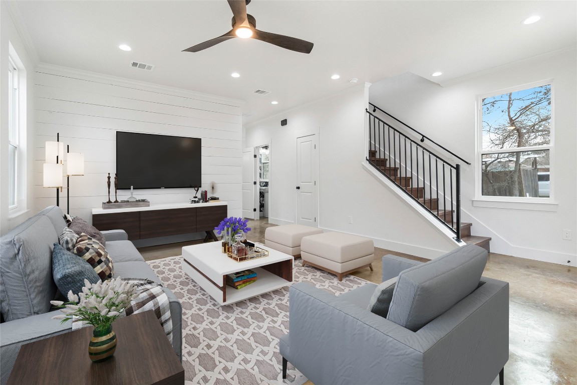 a living room with furniture and a flat screen tv