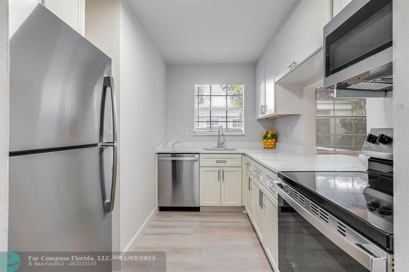 a kitchen with a refrigerator and a sink