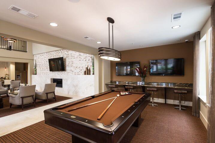 a living room with furniture flat screen tv and kitchen view