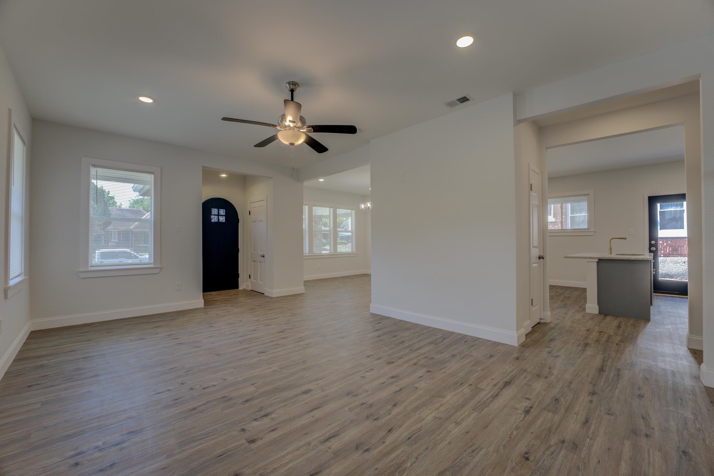 Unfurnished living room with ceiling fan and hardwood / wood-style floors