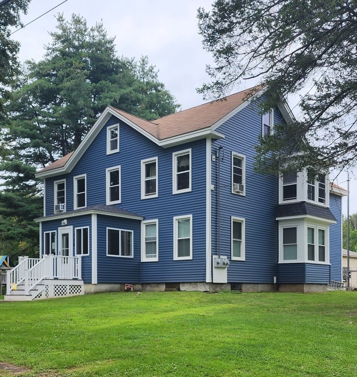 a view of a brick house with a yard