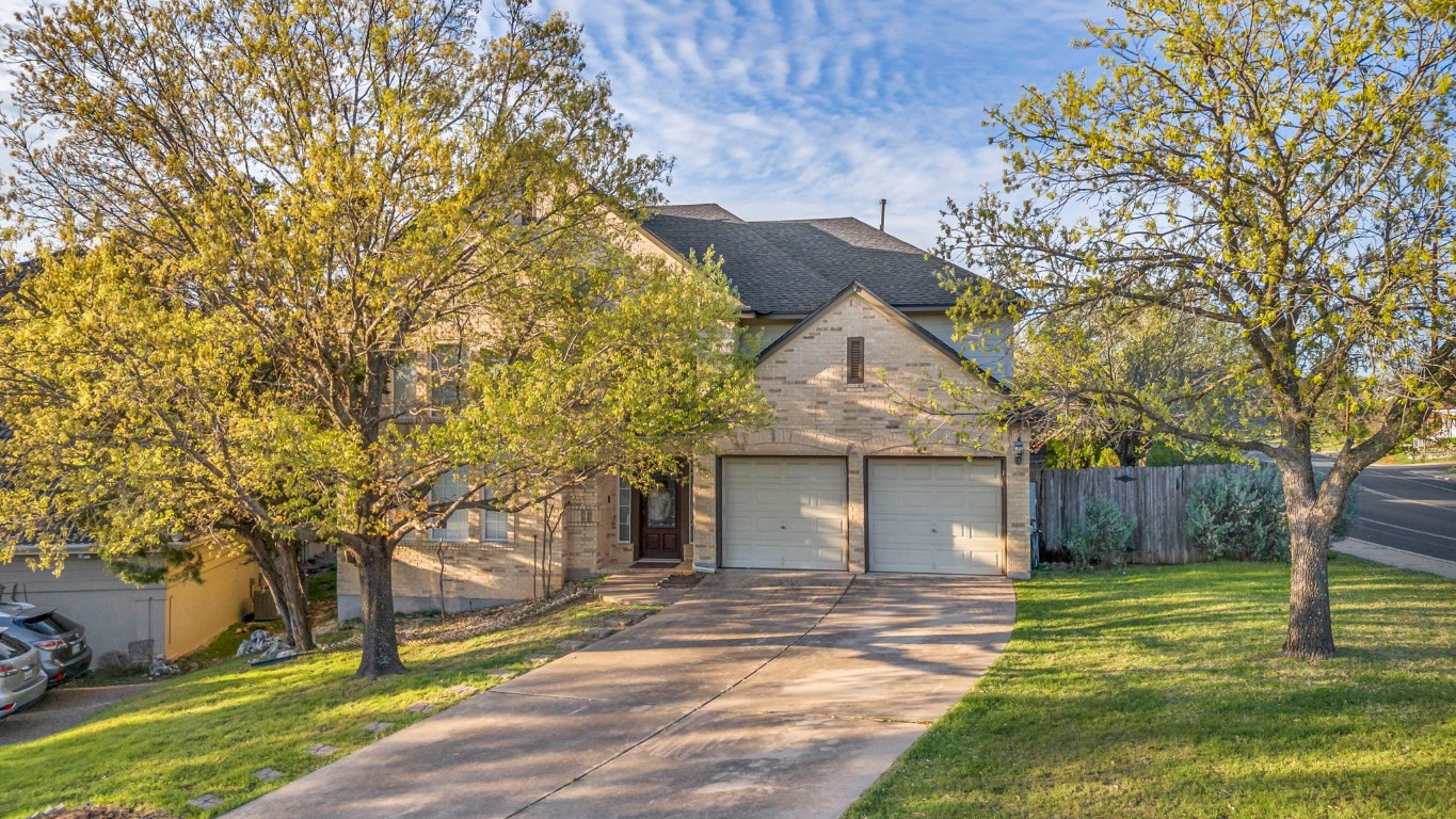 a view of a house with a yard and tree s