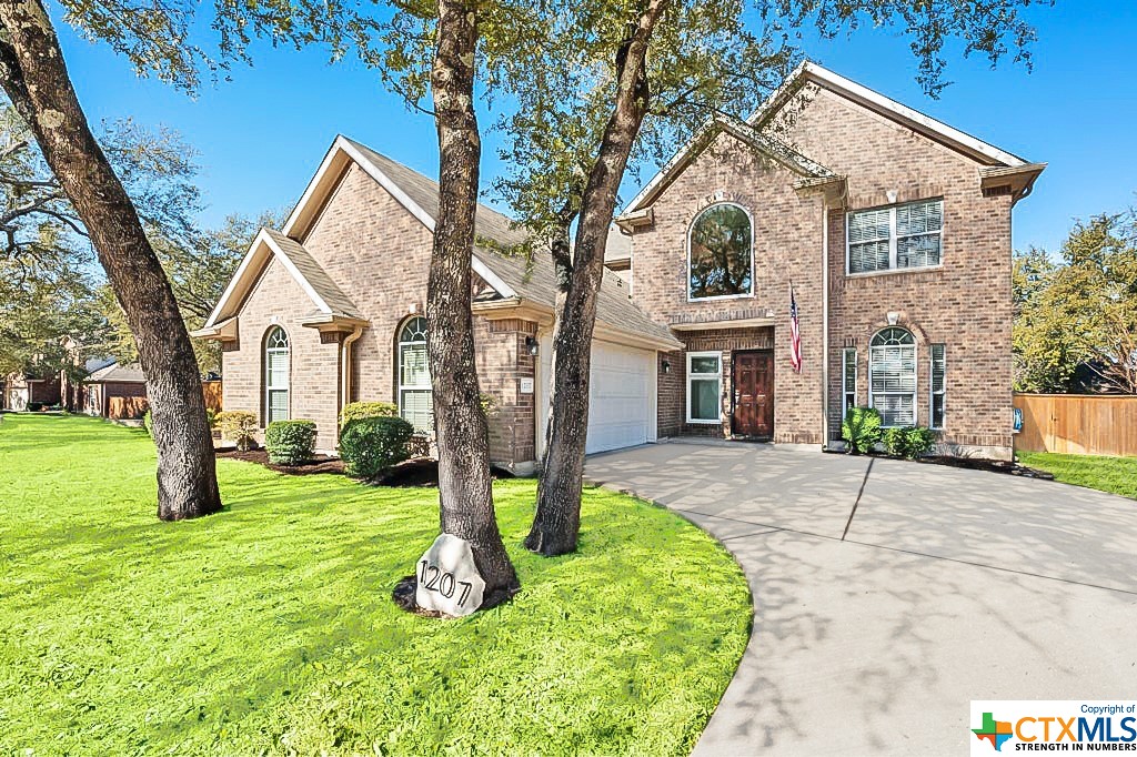 a front view of a house with a yard and garage