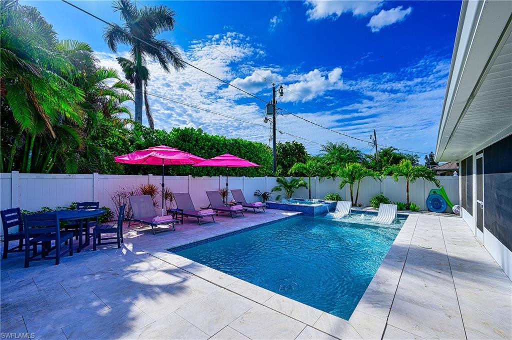 View of pool featuring an in ground hot tub and a patio