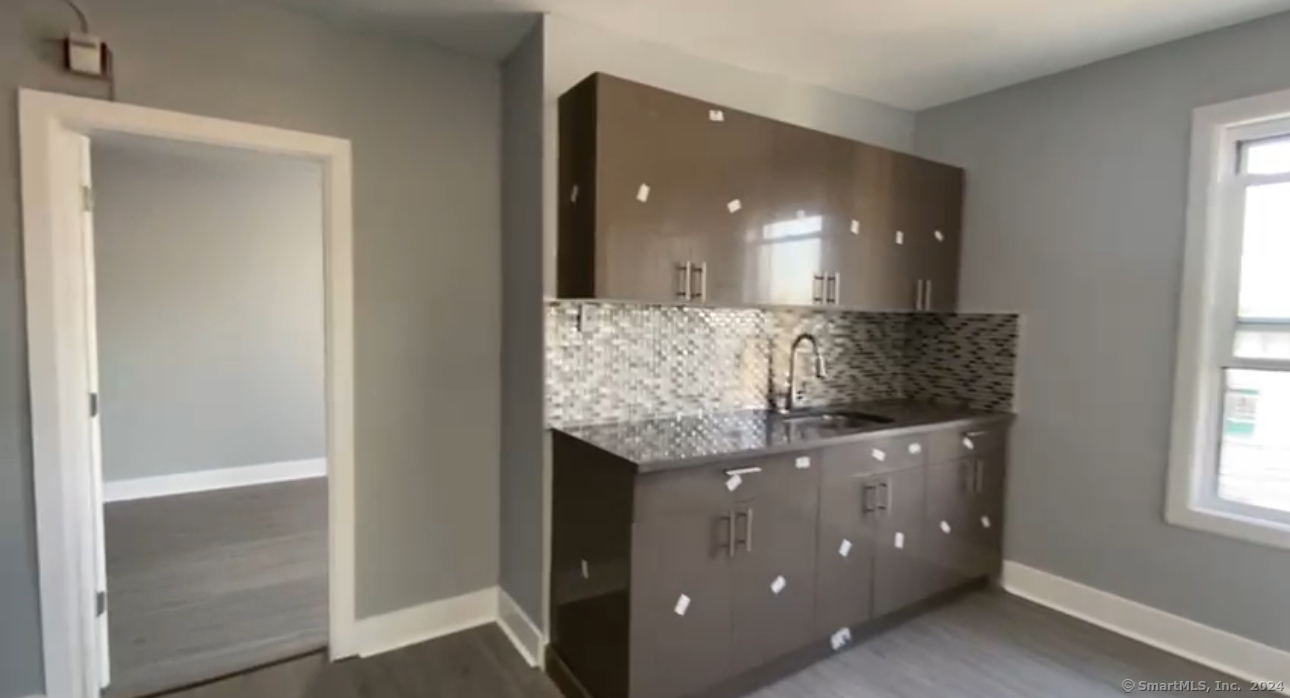 a kitchen with granite countertop a sink and cabinets