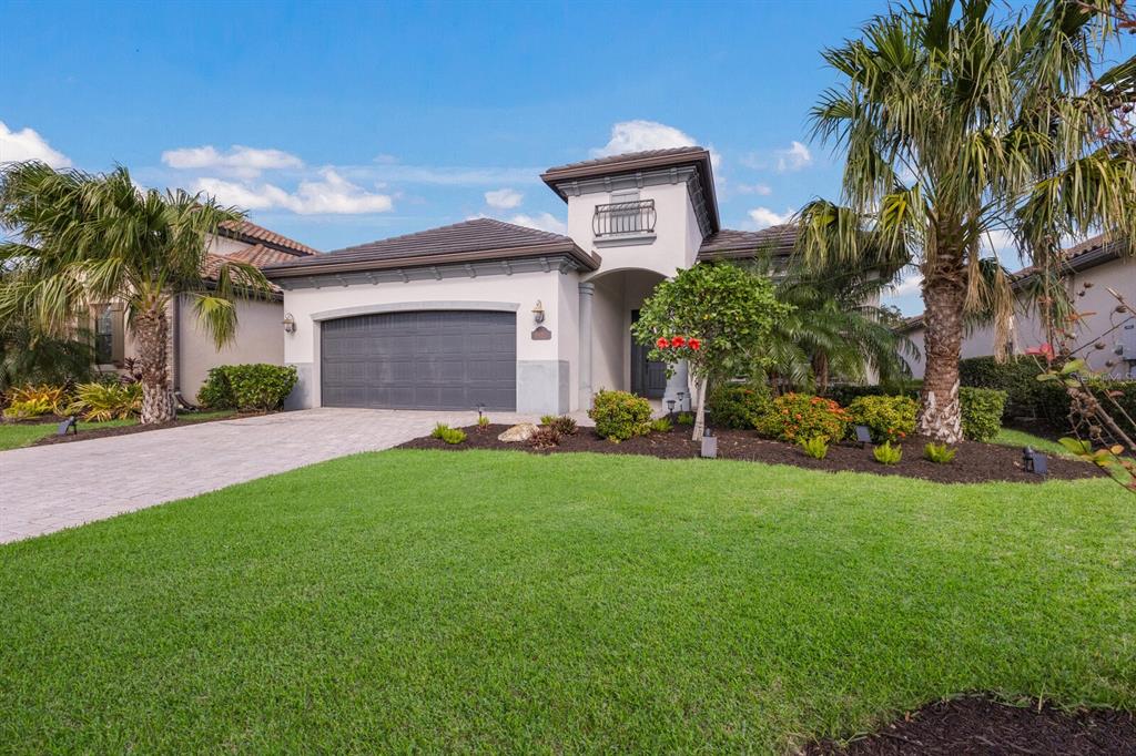 a front view of a house with a yard and garage