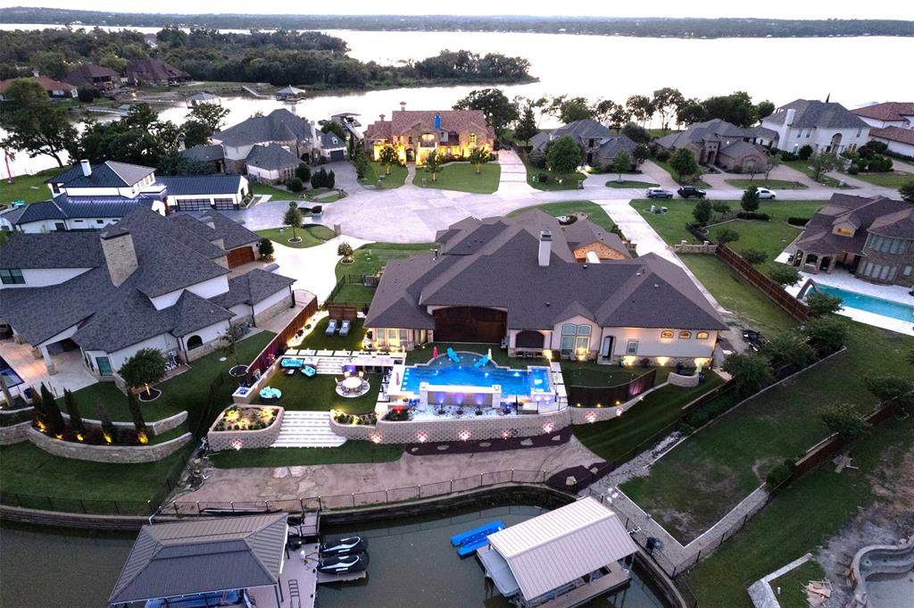 an aerial view of a house with a garden and lake view