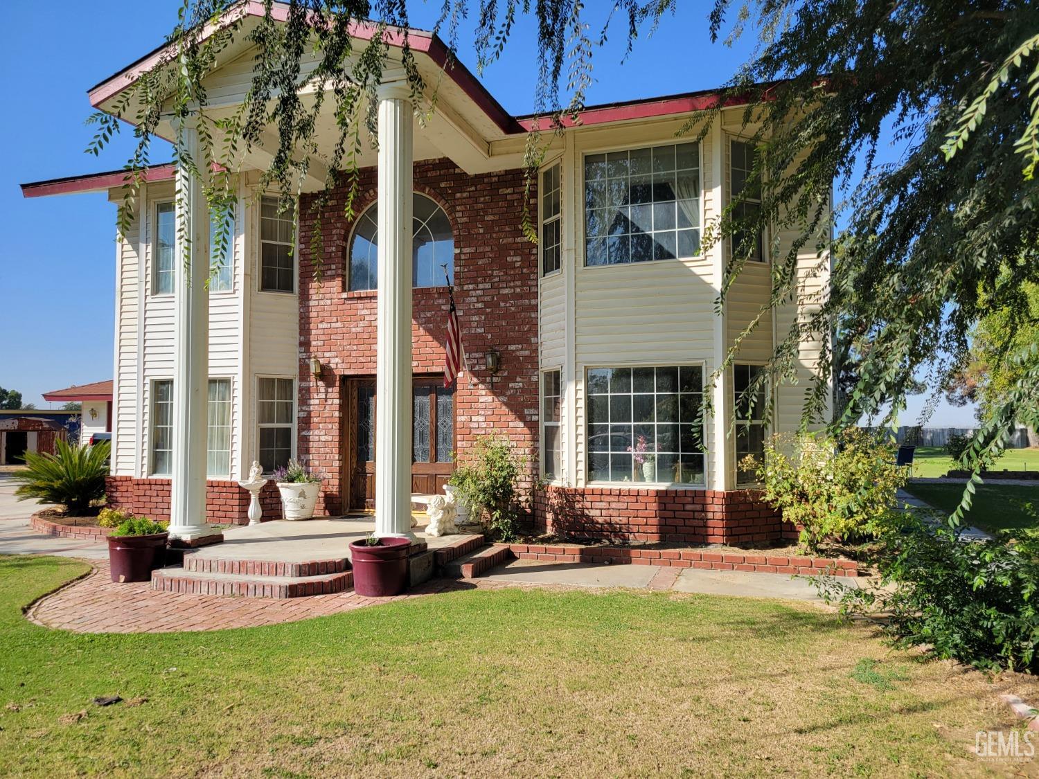 a view of a house with swimming pool patio and a small yard