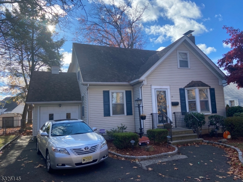 a front view of a house with a yard and outdoor seating