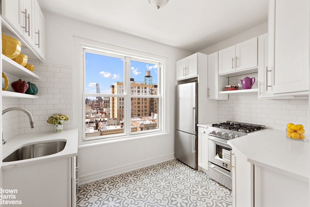 a kitchen with stainless steel appliances a stove a sink and a refrigerator