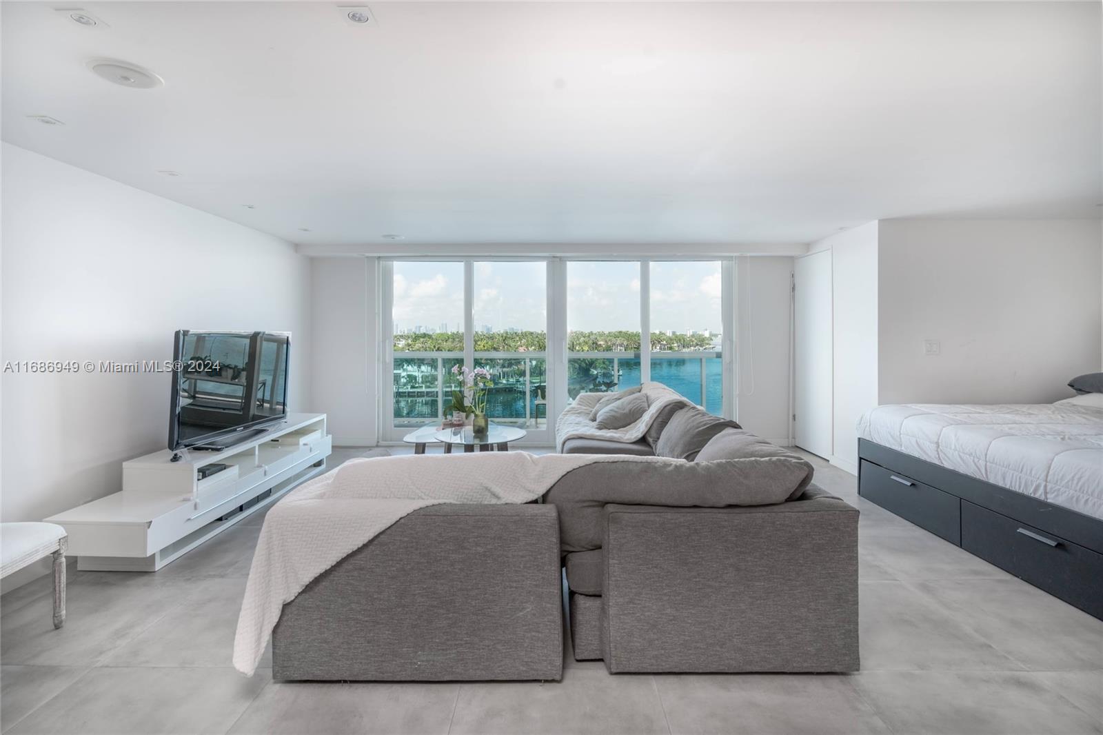 a living room with furniture and a flat screen tv