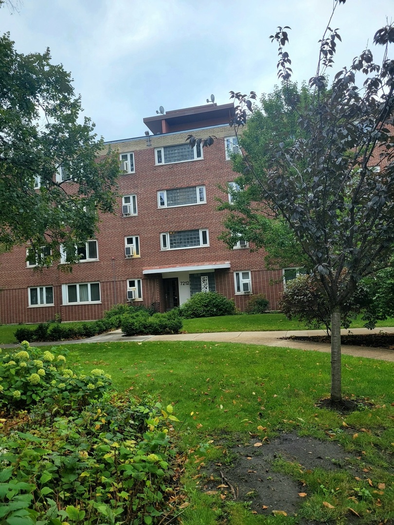 a view of a building with a yard