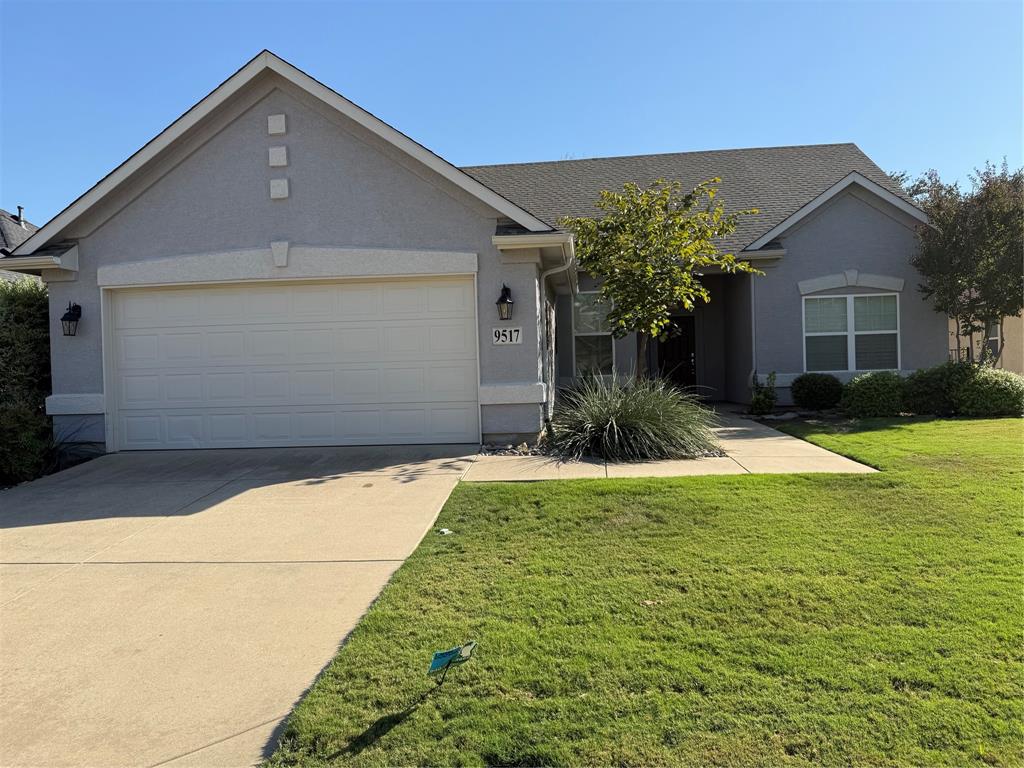 a front view of house with yard and trees around