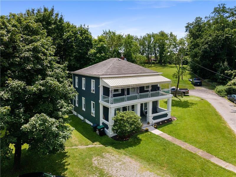 a aerial view of a house with swimming pool and garden