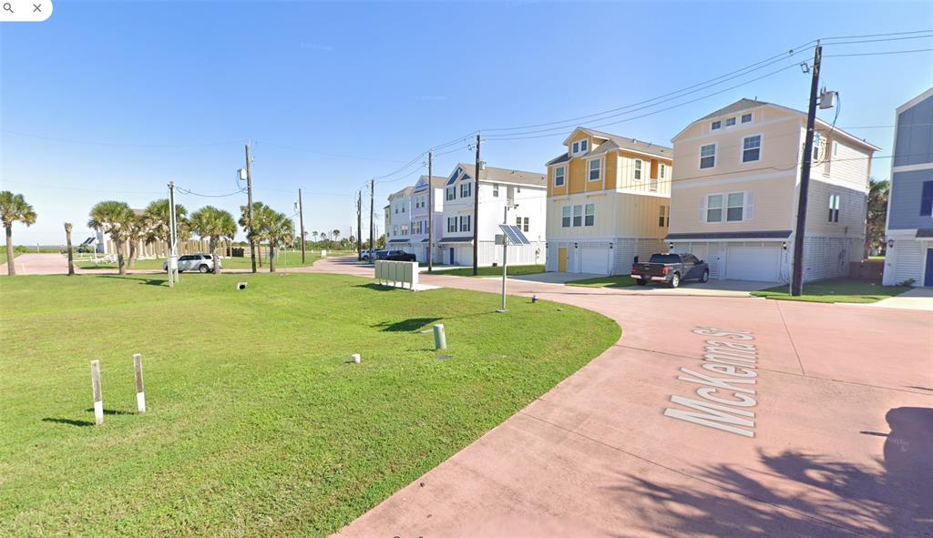 a view of a big building with a big yard and large trees