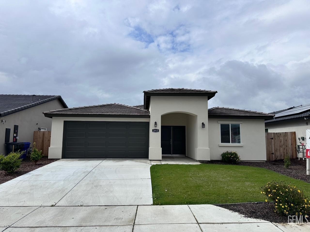 a front view of a house with a yard and garage