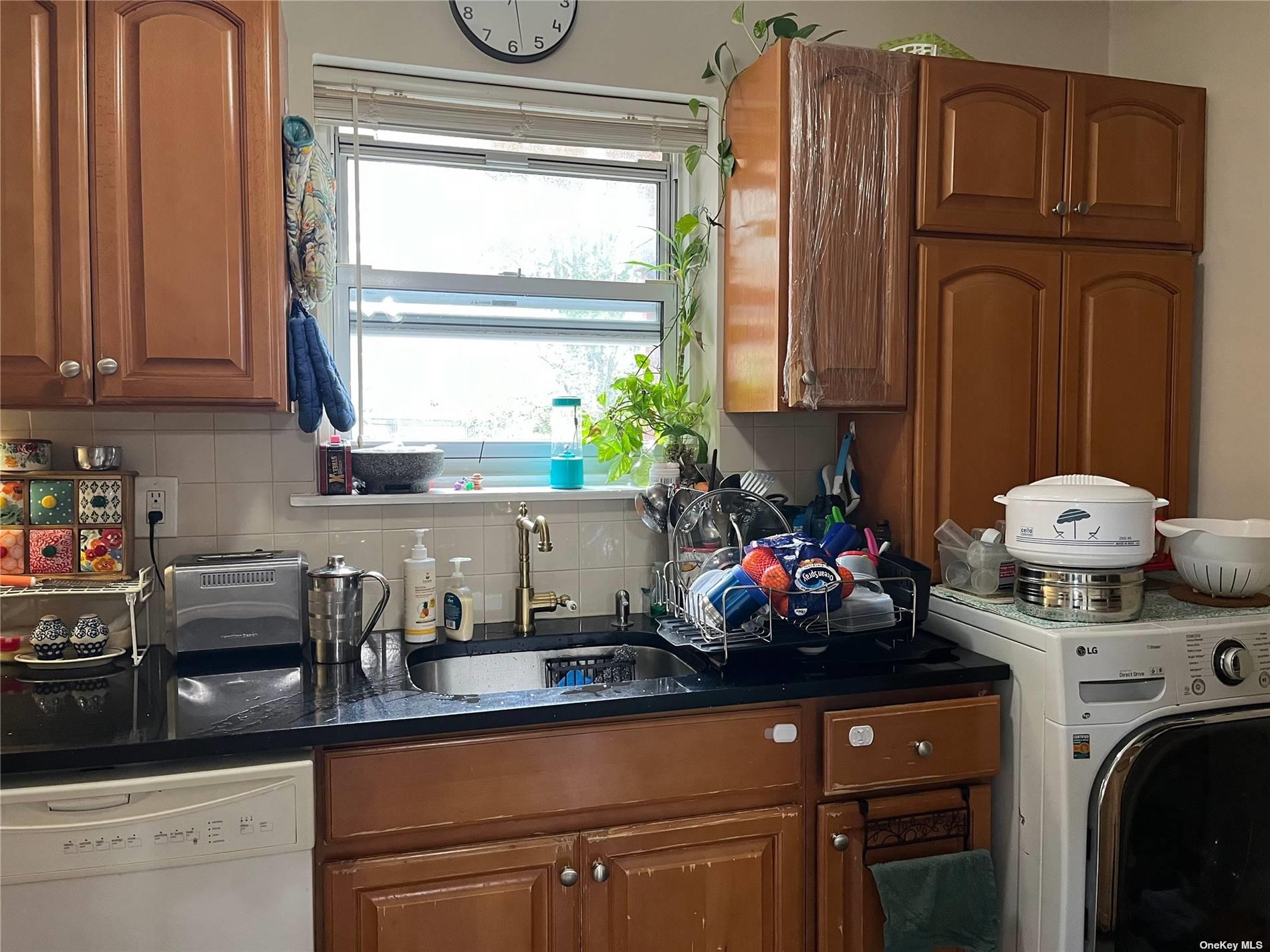 a kitchen with stainless steel appliances granite countertop a sink and cabinets