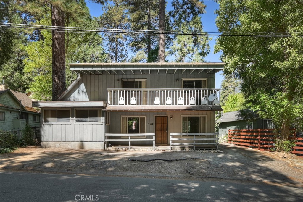 a front view of a house with a tree