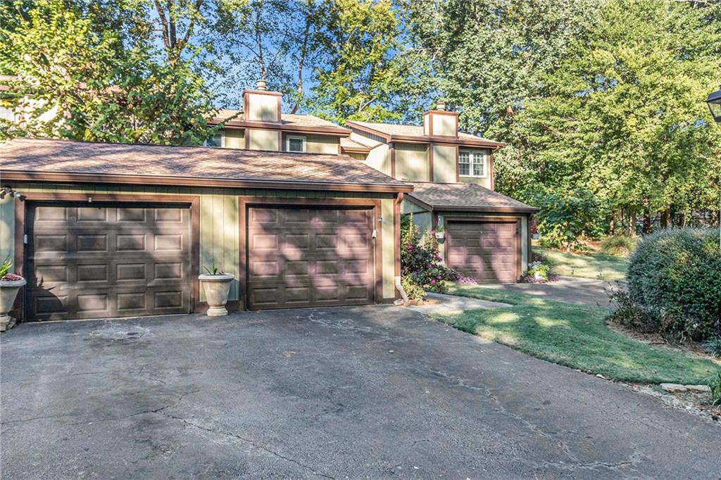 a view of a house with a garage and balcony